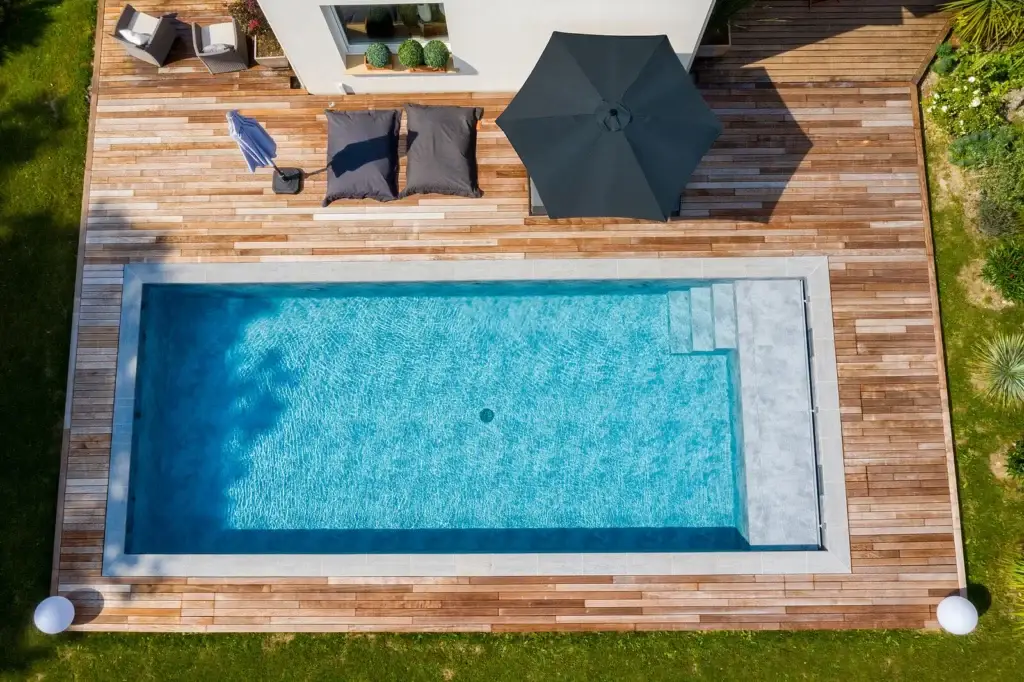 Vue aérienne d’une piscine moderne avec terrasse en bois à côté d’une maison – Design Pool Maroc Marrakech
